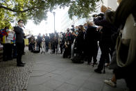 Hong Kong activist Nathan Law, left, speaks as he takes part in a protest during the visit of Chinese Foreign Minister Wang Yi in Berlin, Germany, Tuesday, Sept. 1, 2020. German Foreign Minister Heiko Maas meets his Chinese counterpart at the foreign ministry guest house Villa Borsig for bilateral talks. (AP Photo/Markus Schreiber)