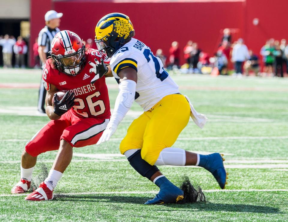 Indiana's Josh Henderson (26) evades Michigan's Michael Barrett (23) for a touchdown during the Indiana versus Michigan football game at Memorial Stadium on Saturday, Oct. 8, 2022.