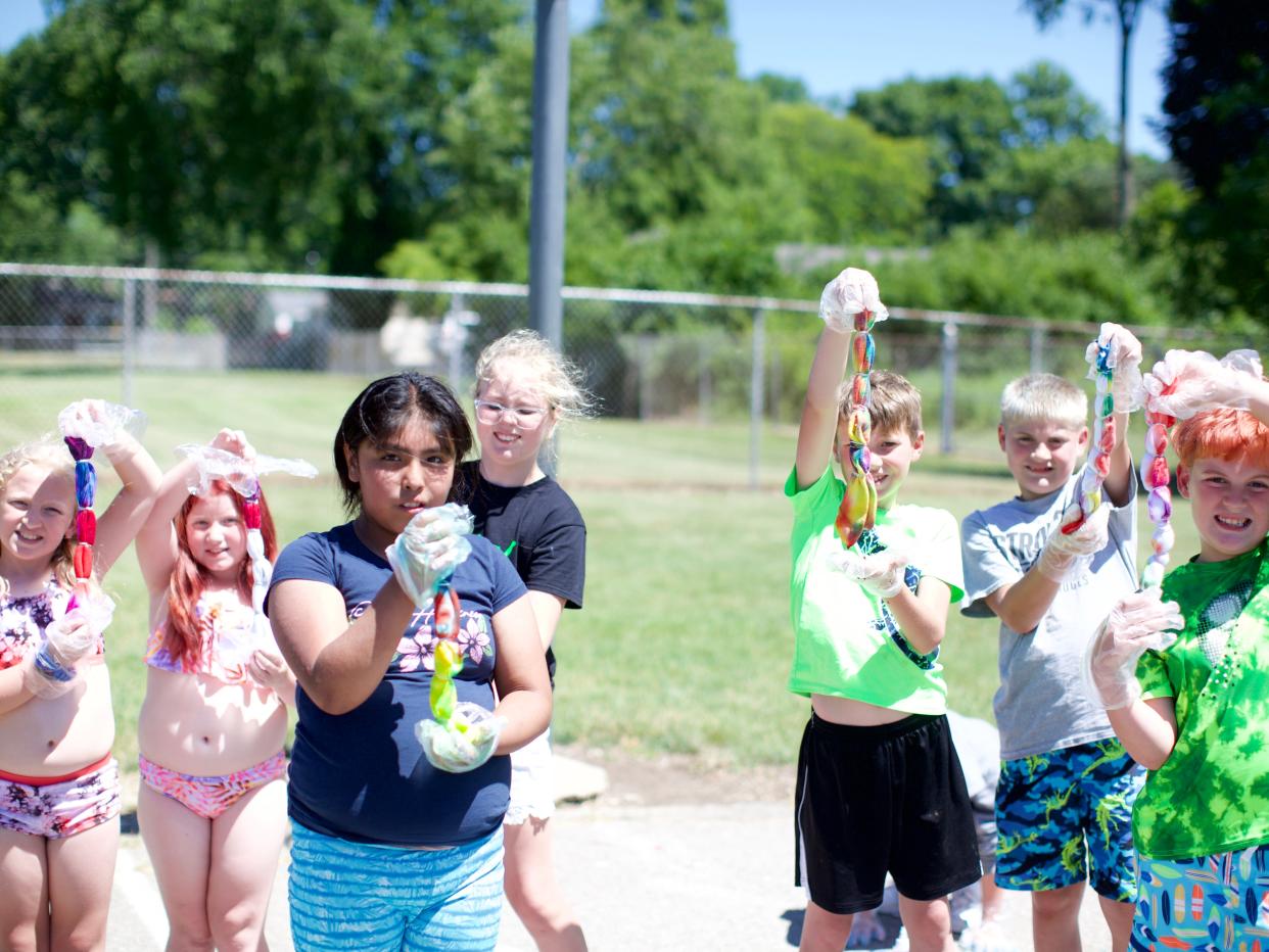 Students at the Y Camp at George Washington Elementary proudly showed the socks they were tie-dying toward the end of the camp day.