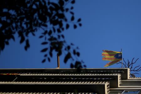 A damaged Estelada (Catalan flag of independence) hangs from a balcony in Barcelona, Spain, October 20, 2017. REUTERS/Ivan Alvarado