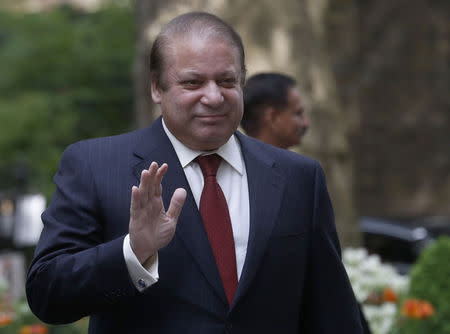 Pakistan's Prime Minister Nawaz Sharif waves as he arrives in Downing Street to meet Britain's Prime Minister David Cameron in London April 30, 2014. REUTERS/Luke MacGregor/Files