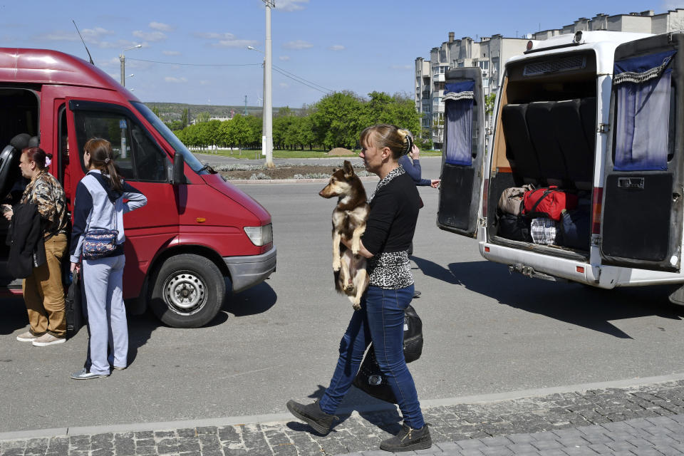 Anastasia, 35, from the Ukrainian village of Kryva Luka, Donetsk region, holds her dog Ryzhik during an evacuation of civilians in Kramatorsk, Ukraine, Tuesday, May 3, 2022. (AP Photo/Andriy Andriyenko)