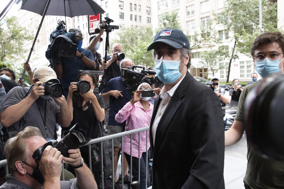 Michael Cohen, President Donald Trump's former personal attorney, returns to his apartment after being released from prison, Friday, July 24, 2020, in New York. District Judge Alvin Hellerstein ordered Cohen released on parole saying he believes the government retaliated against him for writing a book about Trump. (AP Photo/Mark Lennihan)