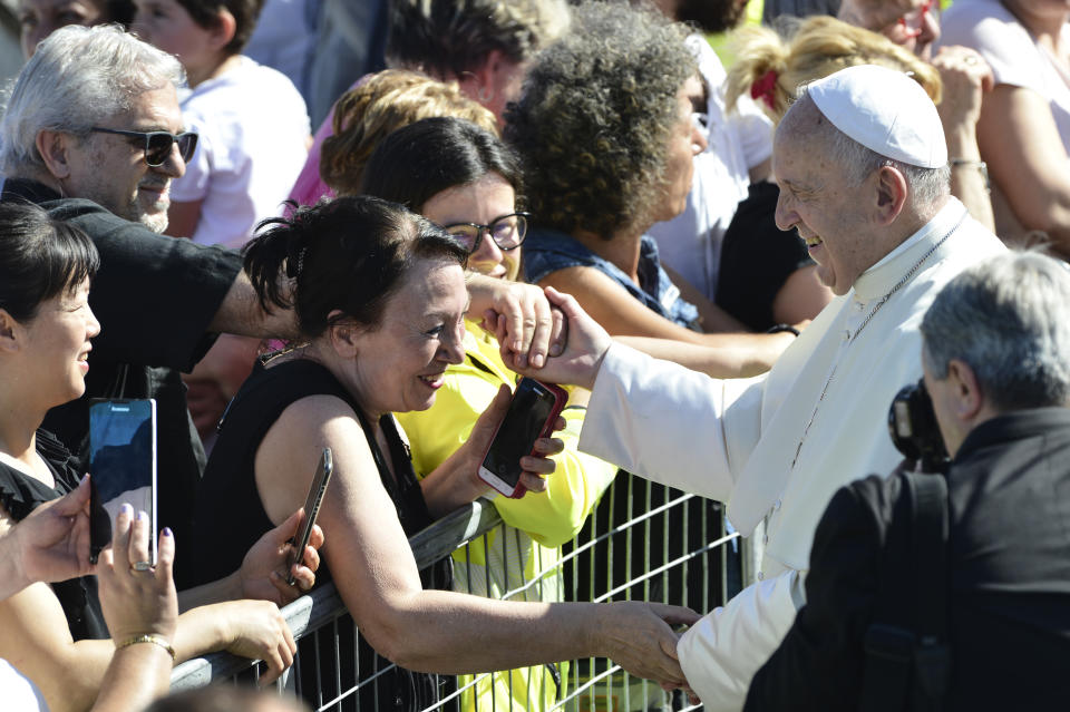 Pope Francis greets residents of temporary houses in the village of Cortine, that was severely damaged by the 2016 earthquake, near Camerino, Italy, Sunday, June 16, 2019. Pope Francis after visiting residents will be celebrating mass in front of the cathedral of Camerino that was also damaged by the 2016 earthquake that hit the central Italian Marche region. (AP Photo/Sandro Perozzi)