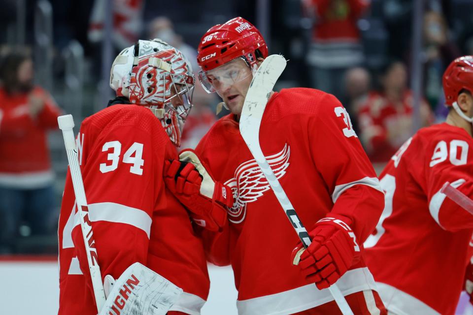Detroit Red Wings goaltender Alex Lyon (34) receives congratulations from right wing Christian Fischer (36) after the game against the Chicago Blackhawks at Little Caesars Arena in Detroit on Thurday, Nov. 30, 2023.
