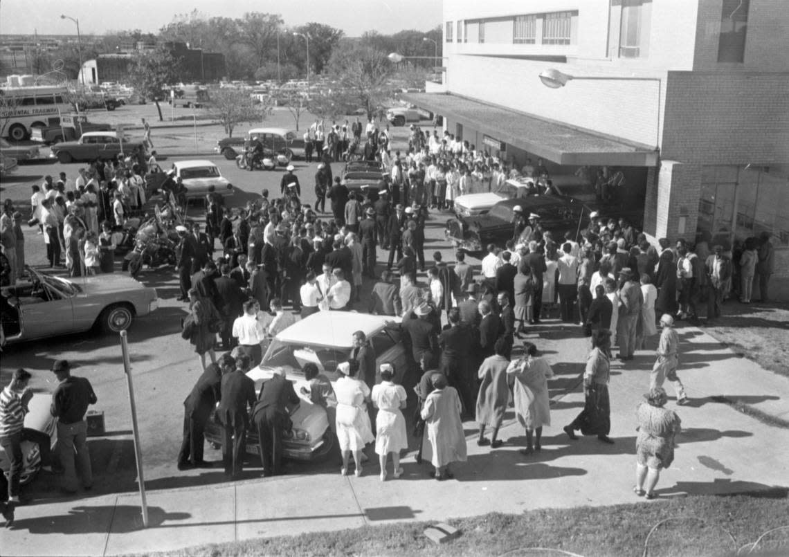 Nov. 22, 1963: Crowd waiting for news of of President John F. Kennedy outside Parkland Hospital emergency room. The black limousine under the portico is the car the president was in when he was shot.