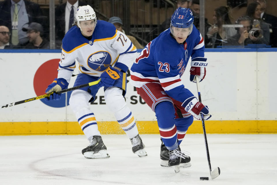 New York Rangers defenseman Adam Fox (23) looks to pass against Buffalo Sabres center Tage Thompson (72) during the second period of an NHL hockey game, Monday, April 10, 2023, in New York. (AP Photo/John Minchillo)
