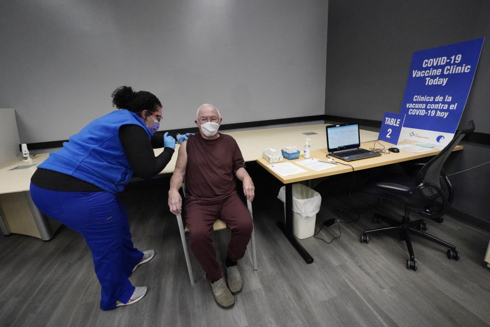 Nurse Maria Maldonado administers a COVID-19 vaccine to 82-year-old David Evans, who had the recently opened vaccination site in Chelsea, Mass., Feb. 10, 2021, mostly to himself. "That went pretty smoothly," he remarked after. "I was preparing for this to be an ordeal after hearing about places where people couldn't get appointments or they didn't have shots." (AP Photo/Elise Amendola)