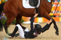 LONDON, ENGLAND - AUGUST 12: Tamara Vega of Mexico riding Douce de Roulad from her mount during the Riding Show Jumping in the Women's Modern Pentathlon on Day 16 of the London 2012 Olympic Games on August 12, 2012 in London, England. (Photo by Alexander Hassenstein/Getty Images)