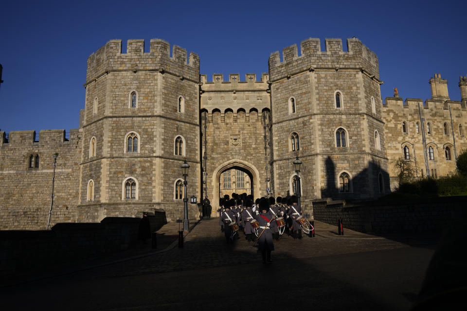 Members of the British Military's 1st Battalion Grenadier Guards Corps of Drums take part in the changing of the guard ceremony outside Windsor Castle in Windsor, England, where Prince Andrew residence is nearby in the grounds of Windsor Great Park, Thursday, Jan. 13, 2022. A judge has — for now — refused to dismiss a lawsuit against Britain's Prince Andrew by an American woman who says he sexually abused her when she was 17. Stressing Wednesday that he wasn't ruling on the truth of the allegations, U.S. District Judge Lewis A. Kaplan rejected an argument by Andrew's lawyers that Virginia Giuffre's lawsuit should be thrown out at an early stage because of an old legal settlement she had with Jeffrey Epstein, the financier she claims set up sexual encounters with the prince. (AP Photo/Matt Dunham)