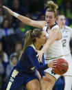 Pittsburgh's Cassidy Walsh (4) dishes out a pass around Notre Dame's Marina Mabrey during an NCAA college basketball game Thursday, Jan. 3, 2019, in South Bend, Ind. (Michael Caterina/South Bend Tribune via AP)