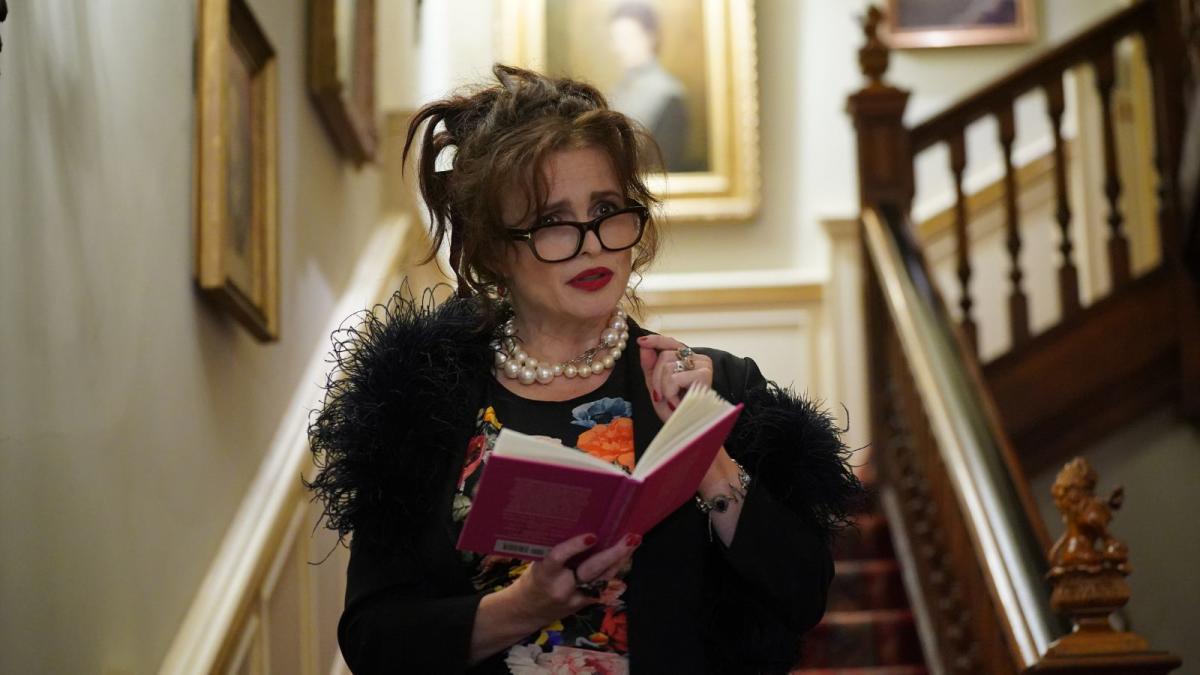 Helena Bonham Carter's black feather boa, red lipstick and pearl necklace  combo oozes 60's glamour at Clarence House