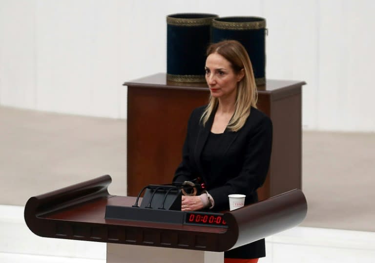 Turkish deputy Aylin Nazliaka handcuffs herself to the podium in a protest during a debate on constitutional reform aimed at strengthening the powers of the president