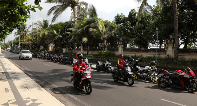 A photo of people travelling on bikes in Indonesia. 