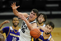 Iowa center Luka Garza (55) fights for a rebound with Western Illinois forward Will Carius, right, during the second half of an NCAA college basketball game, Thursday, Dec. 3, 2020, in Iowa City, Iowa. (AP Photo/Charlie Neibergall)