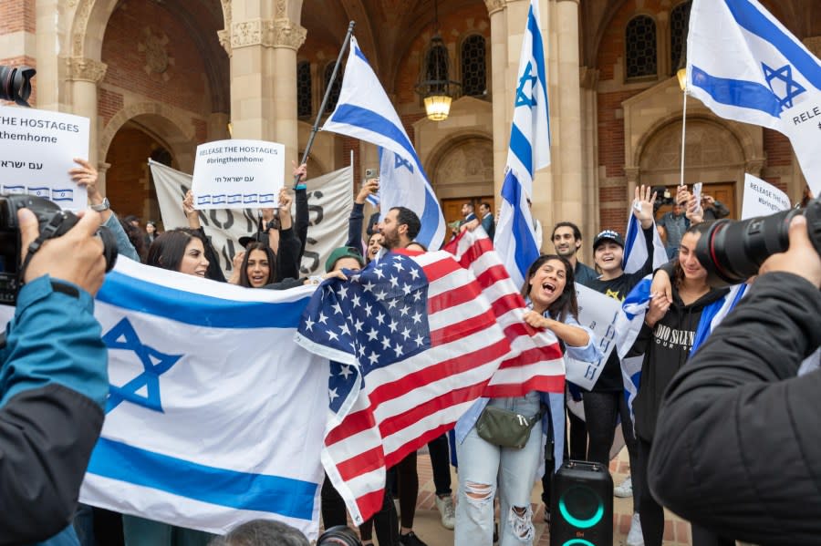 LOS ANGELES, CALIFORNIA – APRIL 25: A group of Israeli, holding flags and banners, face against Pro-Palestinian students as they gather to protest against Israeli attacks on Gaza at University of California (UCLA) in Los Angeles, California, United States on April 25, 2024. (Photo by Grace Hie Yoon/Anadolu via Getty Images)