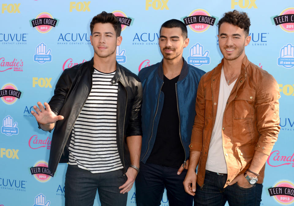 From left, Nick Jonas, Joe Jonas and Kevin Jonas, of musical group The Jonas Brothers, arrive at the Teen Choice Awards at the Gibson Amphitheater on Sunday, Aug. 11, 2013, in Los Angeles. (Photo by Jordan Strauss/Invision/AP)