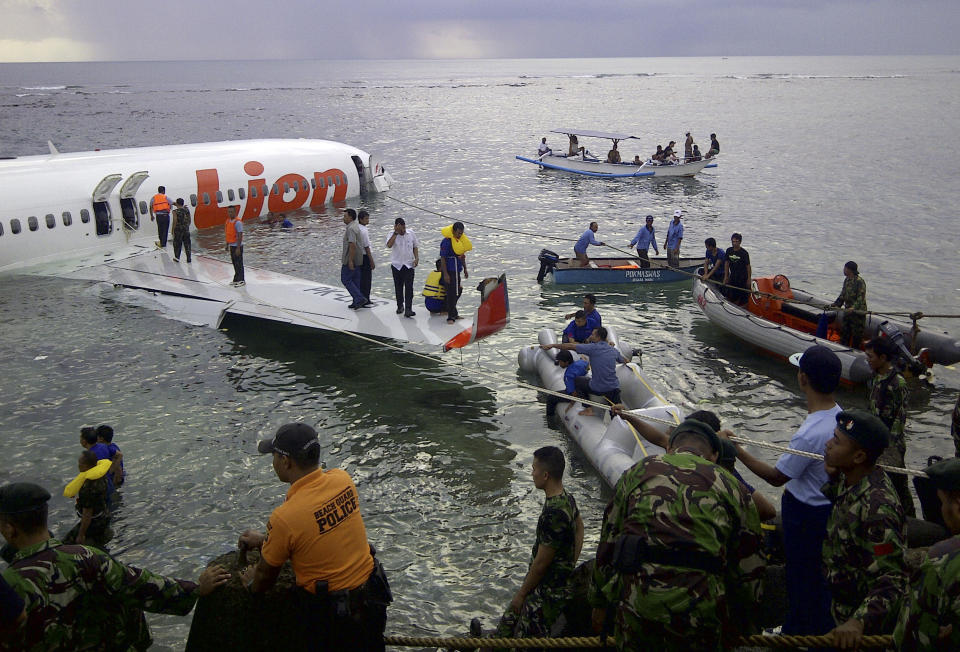 FILE - In this Saturday, April 13, 2013, file photo, released by Indonesia's National Rescue Team rescuers arrive at the crash site of a Lion Air plane in Bali, Indonesia. The plane carrying more than 100 passengers and crew overshot a runway on the Indonesian resort island of Bali on Saturday and crashed into the sea, injuring nearly two dozen people, officials said. (AP Photo/National Rescue Team, File)