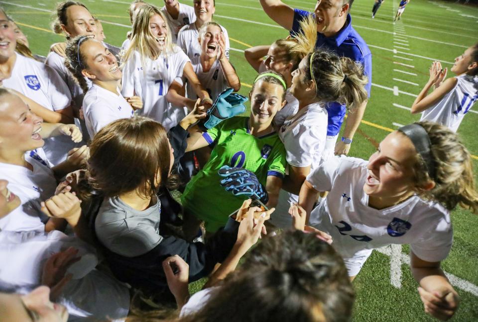 Barron Collier Cougars players celebrate with goalkeeper Paige Knoth (0) after penalty kicks in the Class 5A District 12 game at Staver Field in Naples on Wednesday, Feb. 1, 2023.