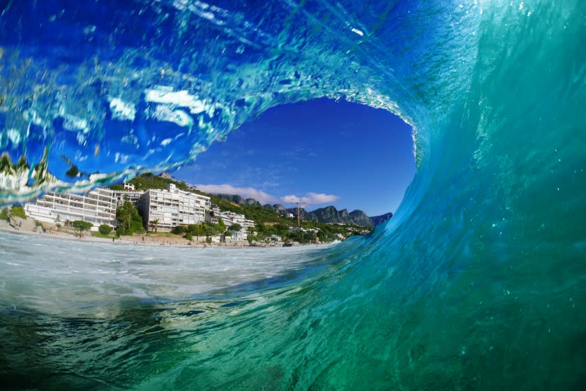 *** EXCLUSIVE *** CLIFTON BEACH, CAPE TOWN, SOUTH AFRICA - FEBRUARY 2017: The perspective from inside a breaking wave looking out at the luxury buildings of Clifton and the beautiful mountains behind them. A daring photographer is braving the wild surf to capture amazing wave shots in South Africa. Avid surfer, Marck Botha has captured the incredible power of waves rising and crashing in the India Ocean, showing colourful formations from above and below the surface. Shot in February, 2017, Marck was enjoying a trip photographing Cape Town when a massive cyclone swell hit Durban and he jumped in to enjoy the huge waves. PHOTOGRAPH BY Marck Botha / Barcroft Images London-T:+44 207 033 1031 E:hello@barcroftmedia.com - New York-T:+1 212 796 2458 E:hello@barcroftusa.com - New Delhi-T:+91 11 4053 2429 E:hello@barcroftindia.com www.barcroftimages.com (Photo credit should read Marck Botha / Barcroft Media via Getty Images / Barcroft Media via Getty Images)