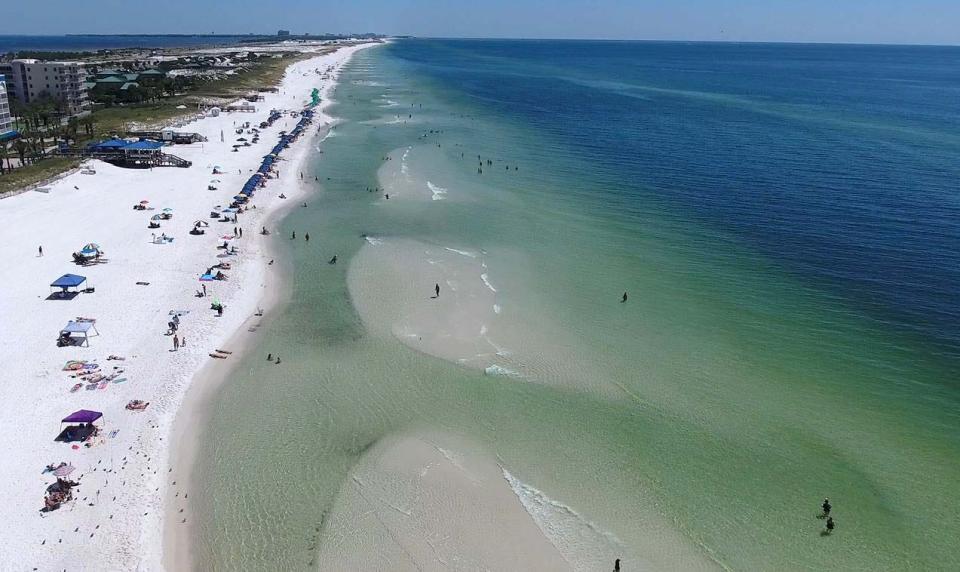 Rip currents leave their mark along the shoreline in this aerial photograph taken near The Boardwalk  on Okaloosa Island. The energy from Incoming waves move back from the shoreline, carrying water, sand, and sometimes swimmers. 