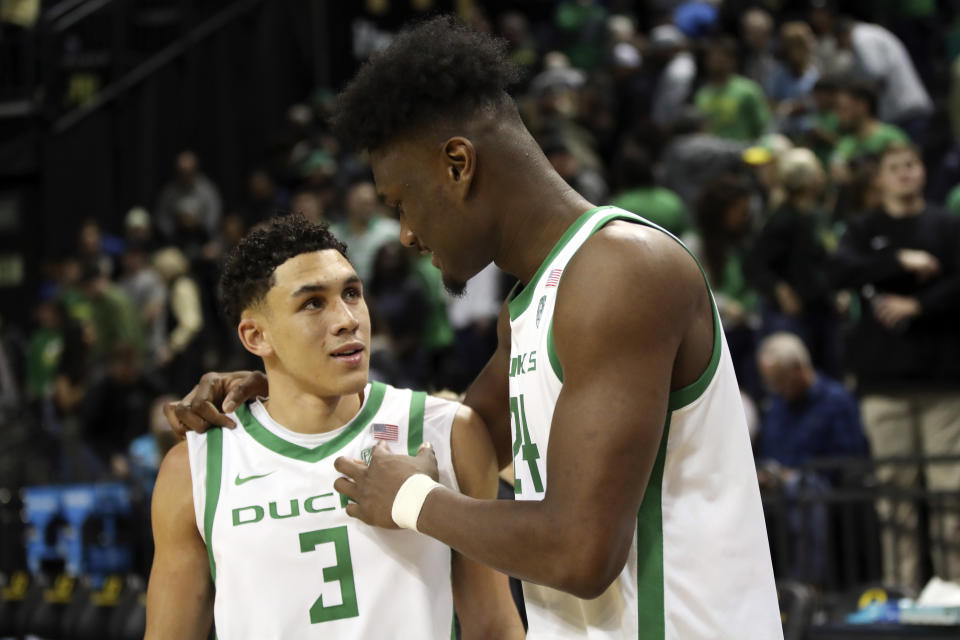 Oregon forward Mahamadou Diawara (24) talks with guard Jackson Shelstad (3) following their team's 64-59 win over UCLA in an NCAA college basketball game in Eugene, Ore., Saturday, Dec. 30, 2023. (AP Photo/Amanda Loman)