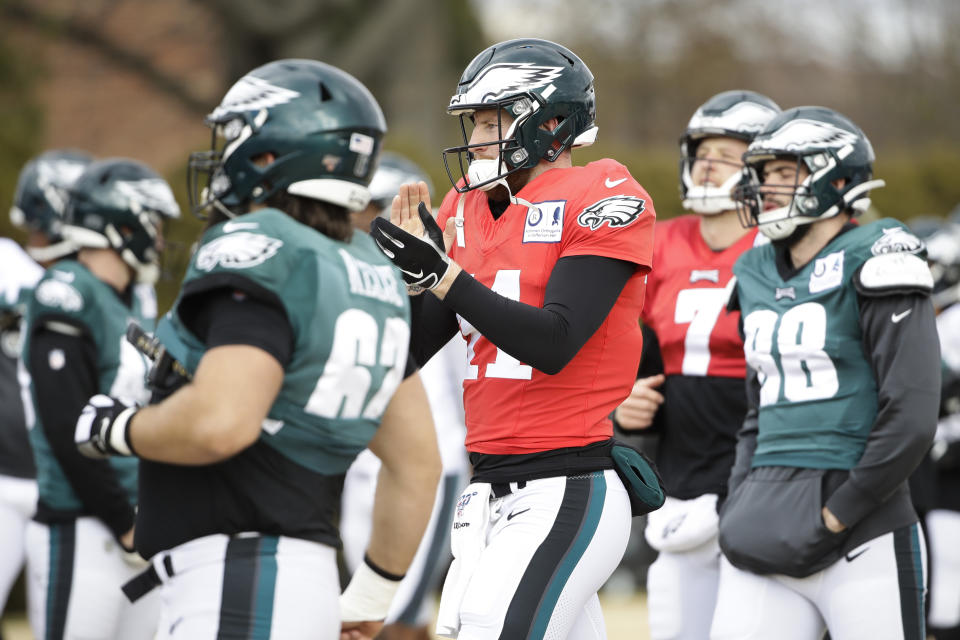 Philadelphia Eagles quarterback Carson Wentz, center, gathers with his teammates at the NFL football team's practice facility in Philadelphia, Thursday, Dec. 5, 2019. (AP Photo/Matt Rourke)