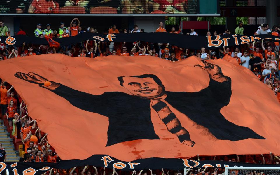 Brisbane Roar fans display a giant banner with the image of the team's coach Ange Postecoglou