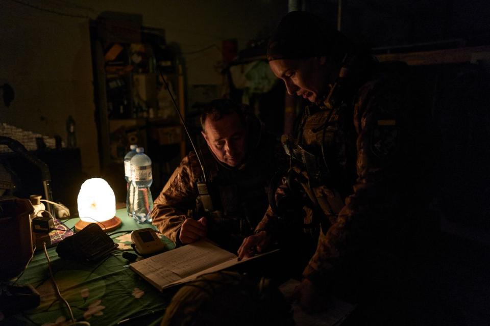 Two Ukrainian soldiers discuss an assault plan in Chasiv Yar, Bakhmut region, frontline Ukraine on Nov. 4, 2023. Russia has reportedly bulked up its forces around the city of Bakhmut in eastern Ukraine. (Vlada Liberova/Libkos/Getty Images)