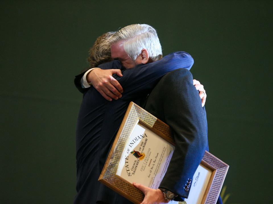 West Lafayette Mayor John Dennis hugs Indiana Gov. Eric Holcomb after receiving the Sagamore of the Wabash Award from the governor, on Monday, Feb. 6, 2023, in Lafayette, Ind.