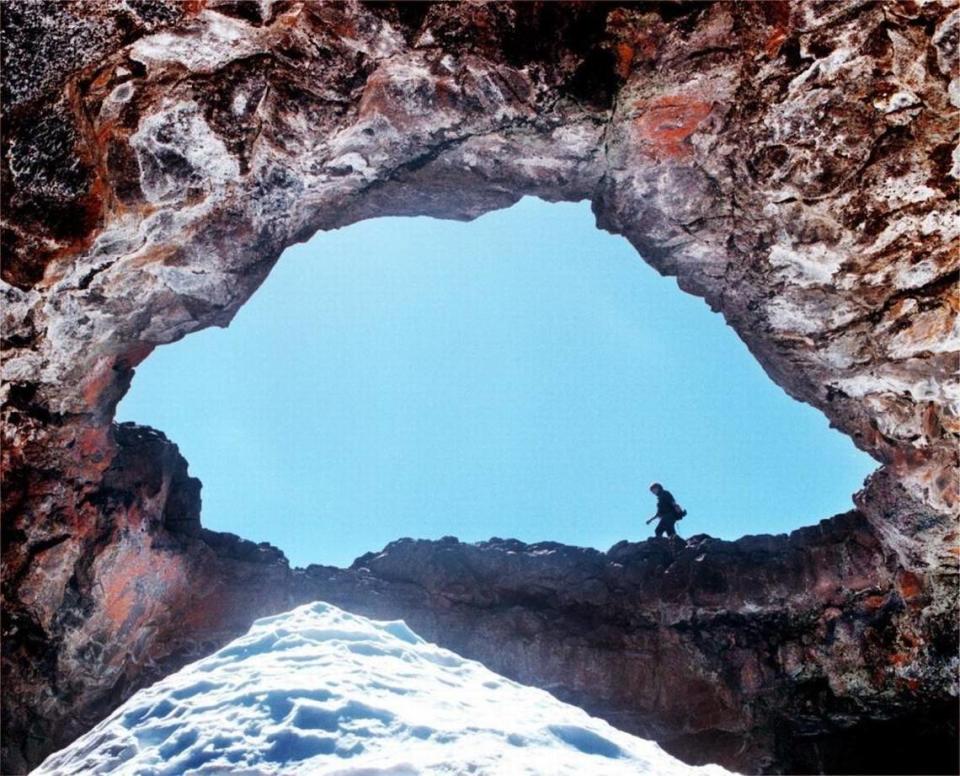 Hiker is framed at Idaho’s Craters of the Moon National Monument.