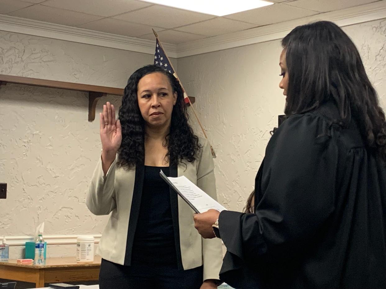 Antoinette East-Jenkins, left, is read the oath of office by Summit County Domestic Relations Court Judge Kani Hightower before she joins the Stow-Munroe Falls school board.