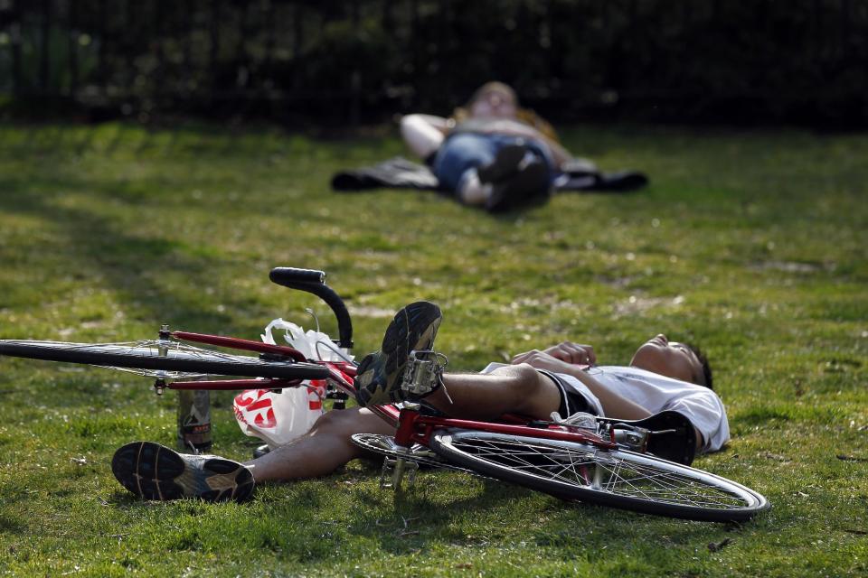 People recline during the unseasonably warm weather in the Rittenhouse Square park Tuesday, March 13, 2012 in Philadelphia. (AP Photo/Alex Brandon)