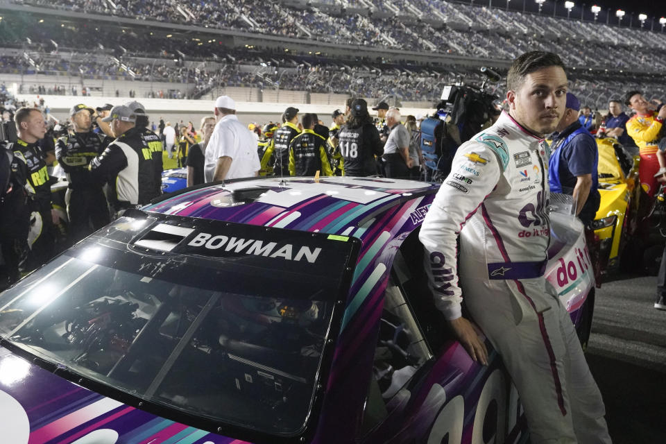 Alex Bowman leans on his car on pit road awaiting the start of the first of two qualifying auto races for the NASCAR Daytona 500 at Daytona International Speedway, Thursday, Feb. 16, 2023, in Daytona Beach, Fla. (AP Photo/John Raoux)