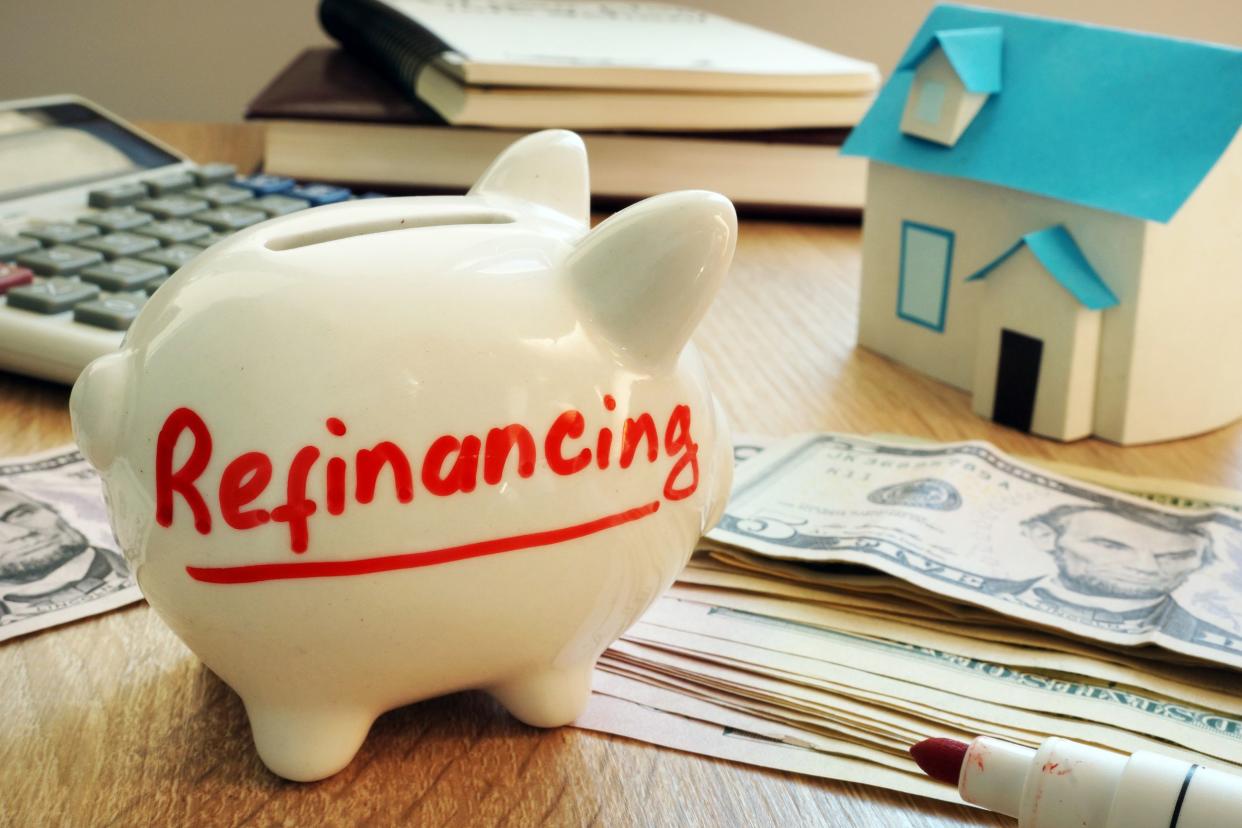 refinancing written on a piggy bank