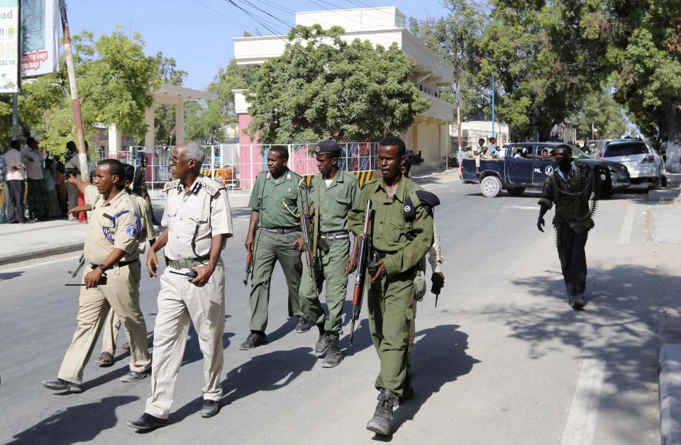 A team of senior Somali policemen arrive at the Central Hotel after a suicide attack in Mogadishu