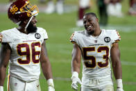 Washington Football Team inside linebacker Jon Bostic (53) and defensive end James Smith-Williams (96) leave the field after an NFL football game against the San Francisco 49ers, Sunday, Dec. 13, 2020, in Glendale, Ariz. Washington won 23-15. (AP Photo/Ross D. Franklin)