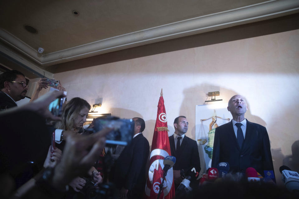 Tunisian law professor Kais Saied speaks to the reporters and supporters Sunday, Oct. 13, 2019 in Tunis. Kais Saied looked set to assume Tunisia's presidency after polling agencies suggested he overwhelmingly won Sunday's runoff election in the country that unleashed the Arab Spring pro-democracy uprisings. (AP Photo/Mosa'ab Elshamy)