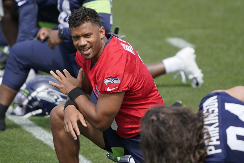 Seattle Seahawks quarterback Russell Wilson stretches at the start of NFL football practice Tuesday, June 8, 2021, in Renton, Wash. (AP Photo/Ted S. Warren)