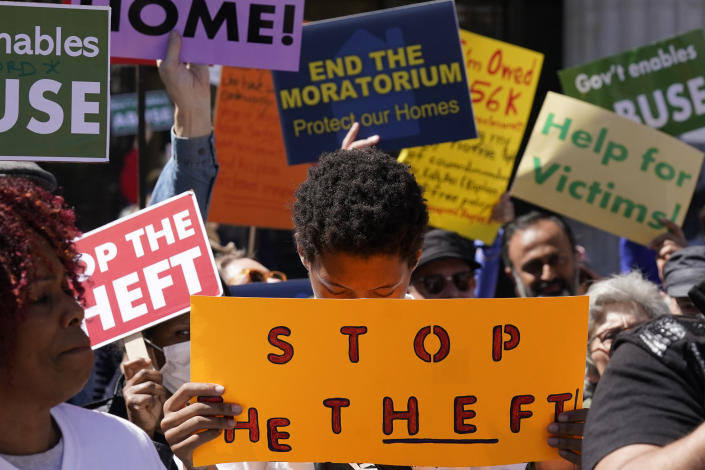 People take part in a rally to end the eviction moratorium outside City Hall in Oakland, Calif., Tuesday, April 11, 2023. Some landlords have gone without rental income for more than three years after Oakland approved an eviction moratorium in March 2020. (AP Photo/Jeff Chiu)