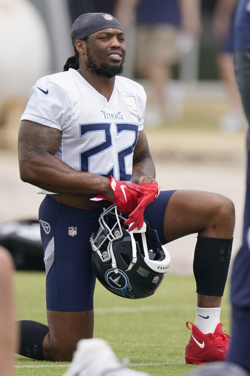 Tennessee Titans running back Derrick Henry (22) stretches during practice at the NFL football team's training facility Wednesday, June 7, 2023, in Nashville, Tenn. (AP Photo/George Walker IV)
