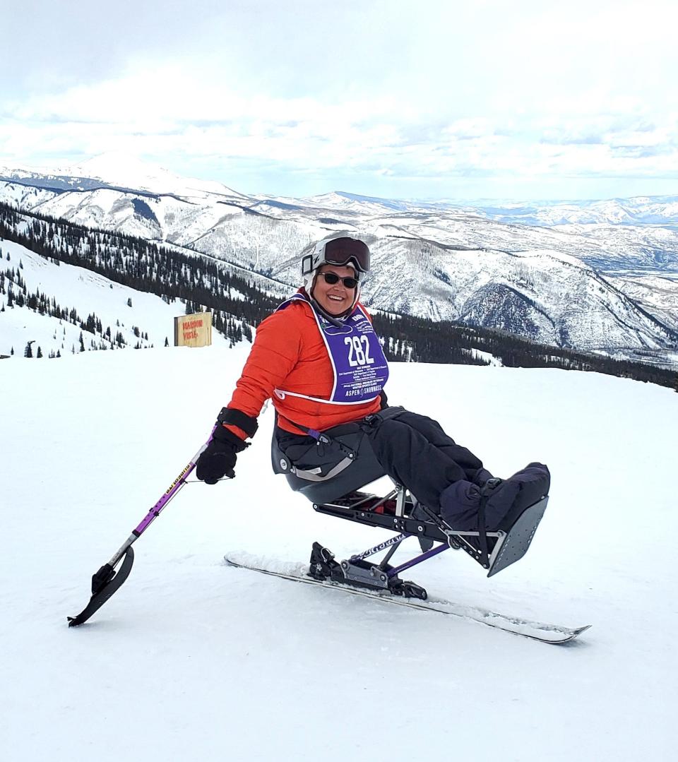 Tina Lavallee, of Pawtucket, balances on her mono-ski high atop Snowmass Mountain in Colorado. Tina sits on a chair attached to a ski via a spring. For stability, she uses outriggers resembling a forearm crutch with a short ski on the bottom.