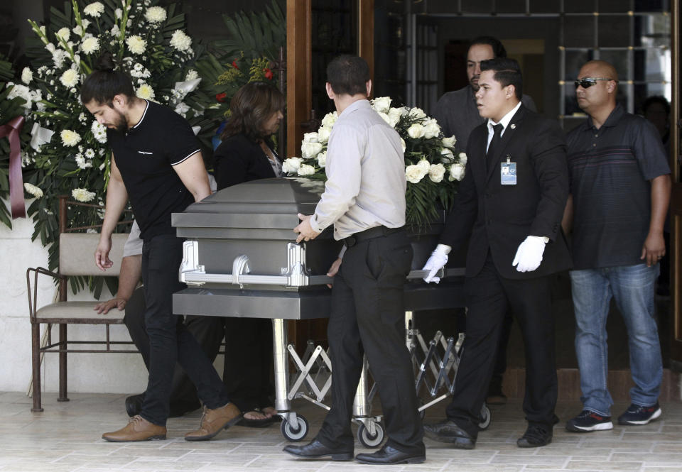 The casket with the body of elementary school principal Elsa Mendoza, of one of the 22 people killed in a shooting at a Walmart in El Paso, is rolled in to her funeral, in Ciudad Juarez, Mexico, Thursday, Aug. 8, 2019. Mexican officials have said eight of the people killed in Saturday's attack were Mexican nationals. (AP Photo/Christian Chavez)