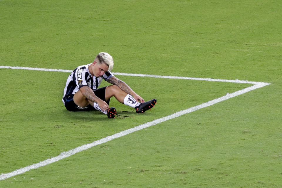 Yeferson Soteldo of Brazil's Santos sits after his side's 0-1 lost against Brazil's Palmeiras during the Copa Libertadores final soccer match at the Maracana stadium in Rio de Janerio, Brazil, Saturday, Jan. 30, 2021. (AP Photo/Silvia Izquierdo)