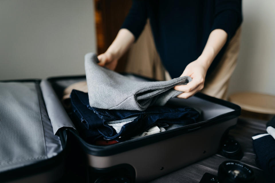 A person packing a bag