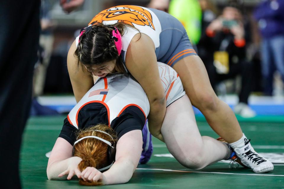Sabrina Nauss of Brighton, top, grapples with Gabriella Allen of Marcellus during Girls Division 190 pounds match at MHSAA individual wrestling state finals at Ford Field in Detroit on Saturday, March 2, 2024.