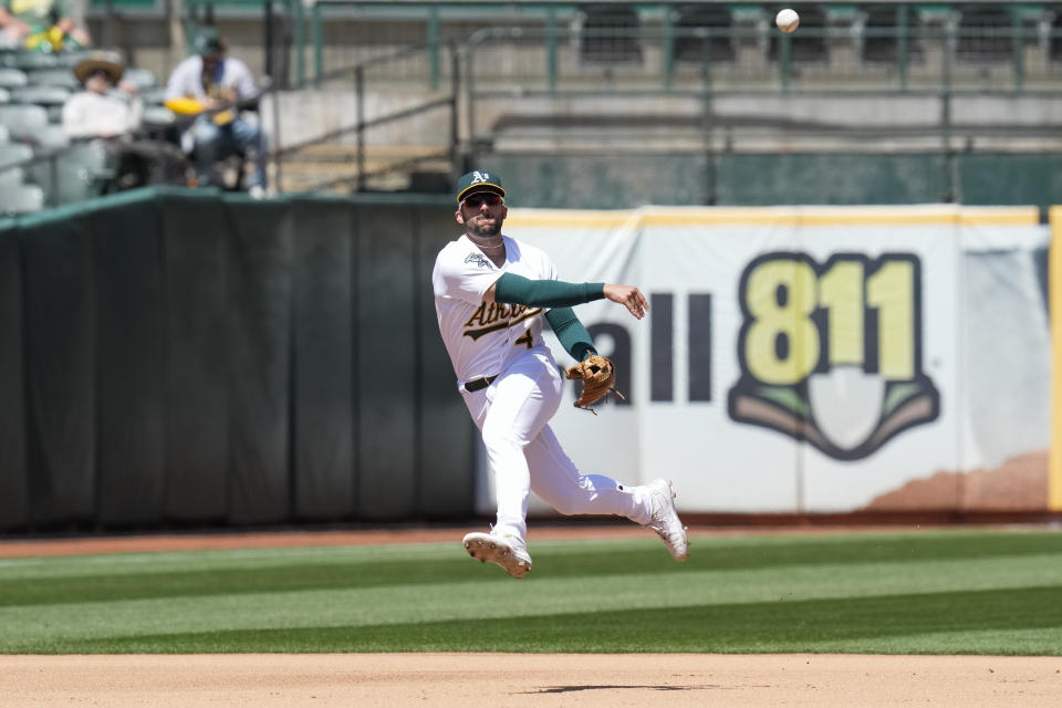 Oakland Athletics shortstop Kevin Smith throws to first for an out on Chicago Cubs' Nico Hoerner during the fifth inning of a baseball game in Oakland, Calif., Wednesday, April 19, 2023. (AP Photo/Godofredo A. Vásquez)