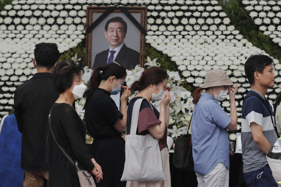 Mourners pass by a memorial altar for late Seoul Mayor Park Won-soon at City Hall Plaza in Seoul, South Korea, Sunday, July 12, 2020. The sudden death of Seoul's mayor, reportedly implicated in a sexual harassment complaint, has prompted an outpouring of public sympathy even as it has raised questions about a man who built his career as a reform-minded politician and self-described feminist. (AP Photo/Ahn Young-joon)