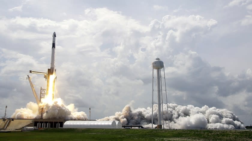 In this Saturday, May 30, 2020 photo SpaceX Falcon 9, with NASA astronauts Doug Hurley and Bob Behnken in the Dragon crew capsule, lifts off from Pad 39-A at the Kennedy Space Center in Cape Canaveral, Fla. For the first time in nearly a decade, astronauts blasted towards orbit aboard an American rocket from American soil, a first for a private company.(AP Photo/John Raoux)