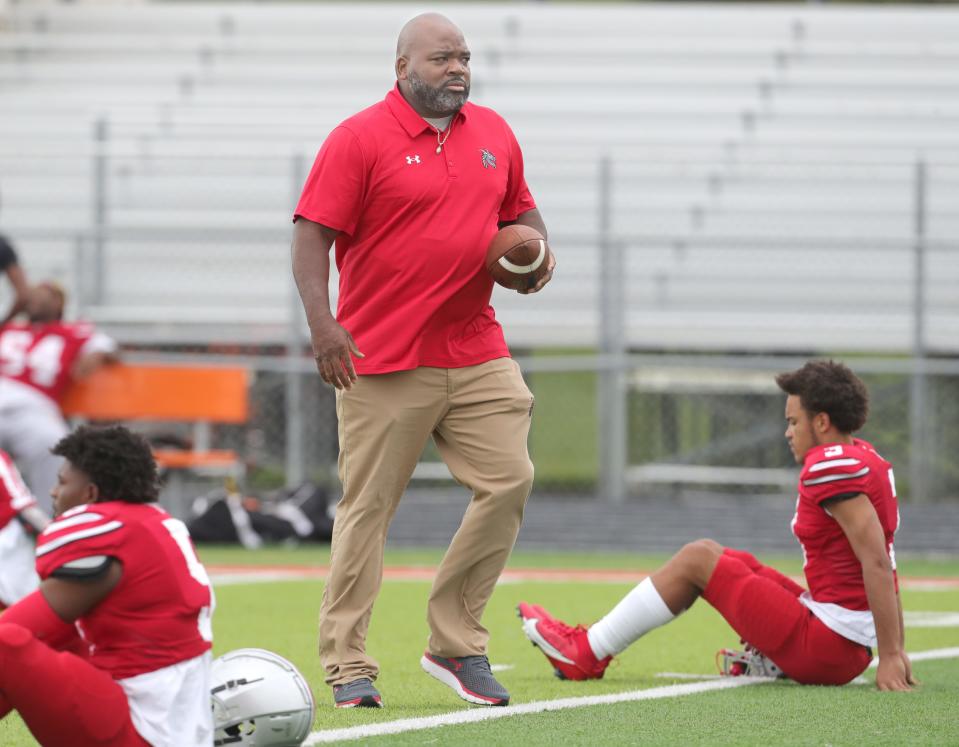 East coach Marques Hayes keeps an eye on his players before the Dragons' game against Youngstown Chaney on Friday in Akron.